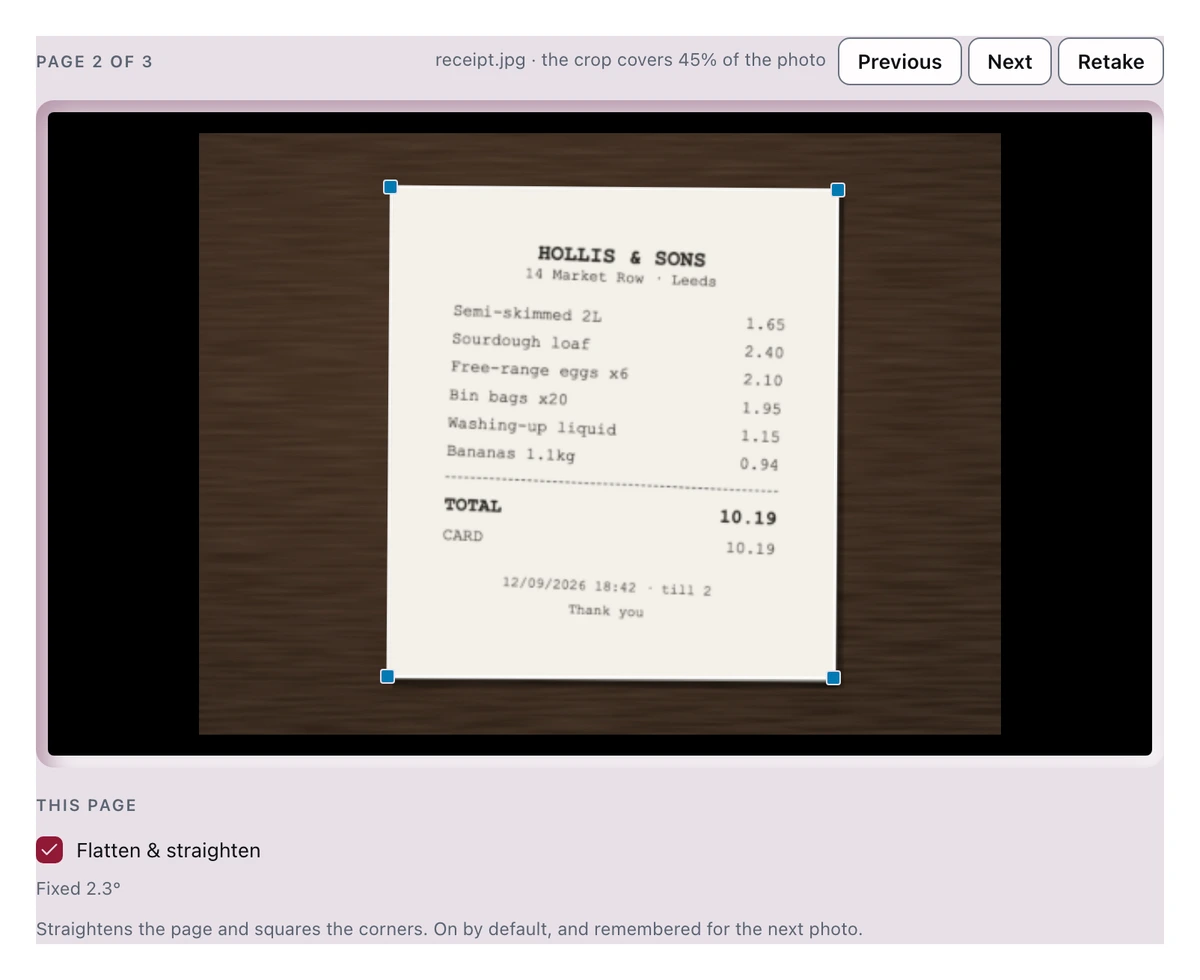 The scanner in Crop mode showing the receipt photo on the desk with four corner handles, and under it the Flatten & straighten switch reporting Fixed 2.3°.